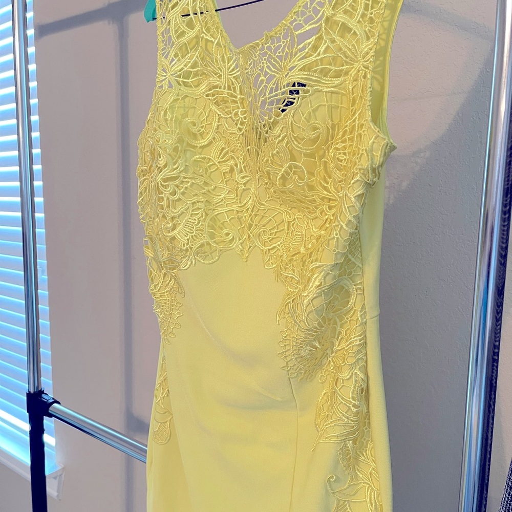 Yellow dress with lace cut out around bodice and down the sides.